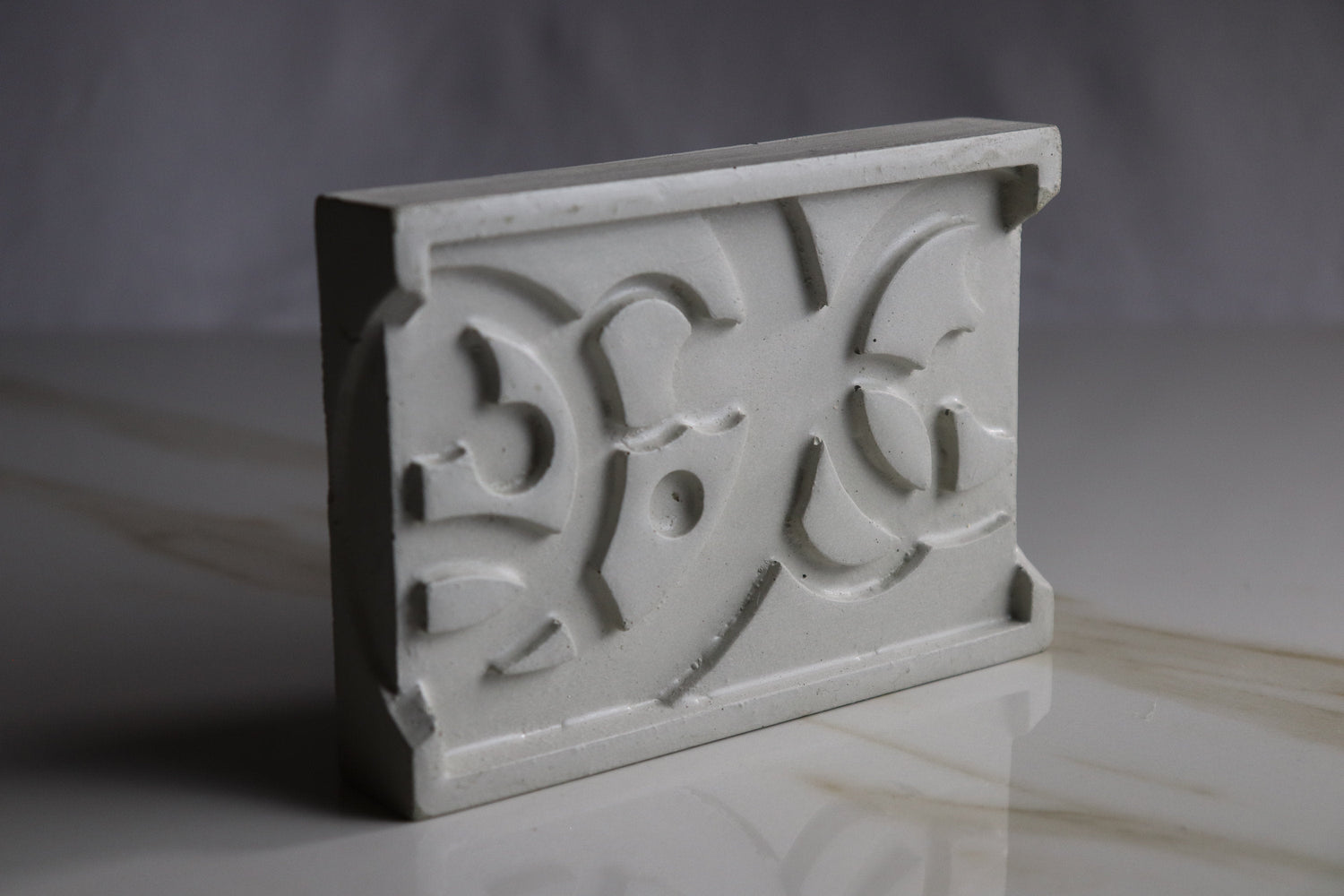 “Abstract concrete soap dish in minimalist modern design, rectangular shape, gray concrete bathroom accessory on countertop.”