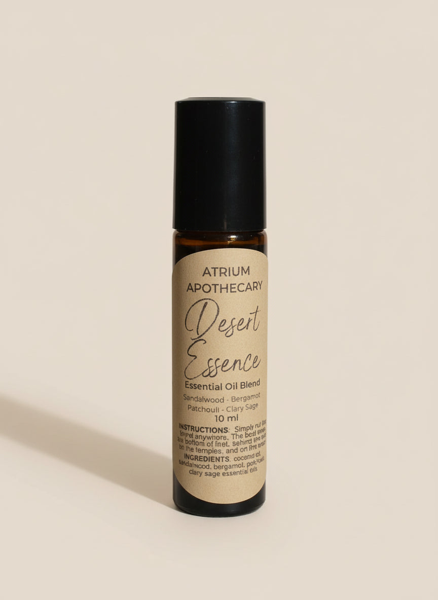 Atrium Apothecary Desert Essence essential oil blend bottle on a white surface with a plant in the background.