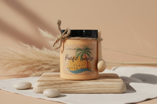 Jar of Atrium Apothecary Pacific Sunrise Clay Sugar Scrub on a wooden block with a white background